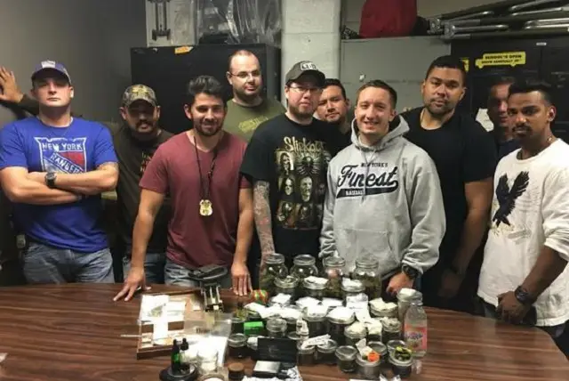 Cops from East Flatbush's 71st Precinct pose with their haul from a Thursday night raid.